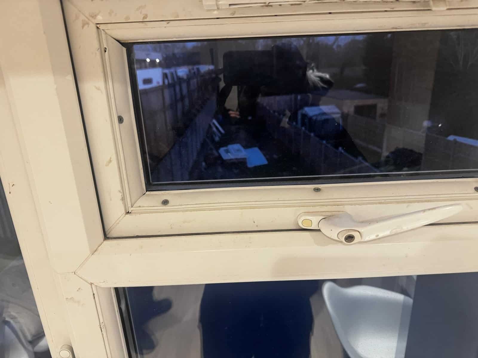 White uPVC window in a Greenford home fitted with black screws through the frame, an example of poor finishing and the wrong fixings