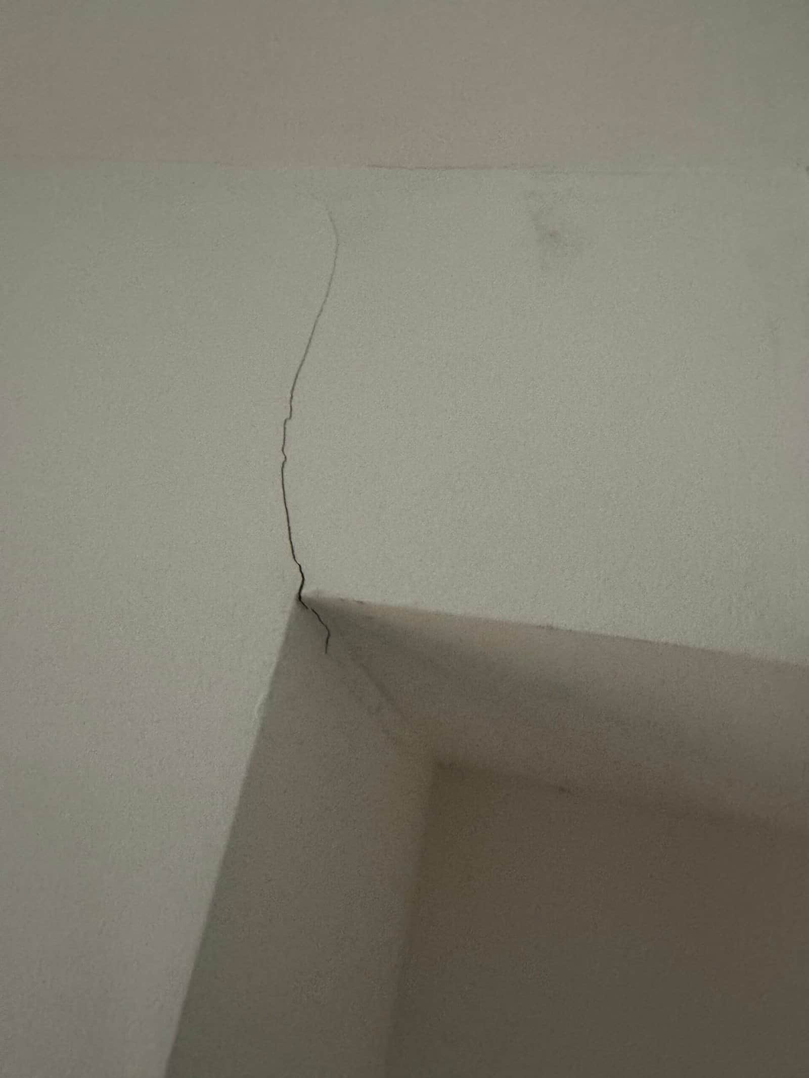 Interior French doors in a Greenford home with rough unfinished plaster reveals and protective film still left on the frames